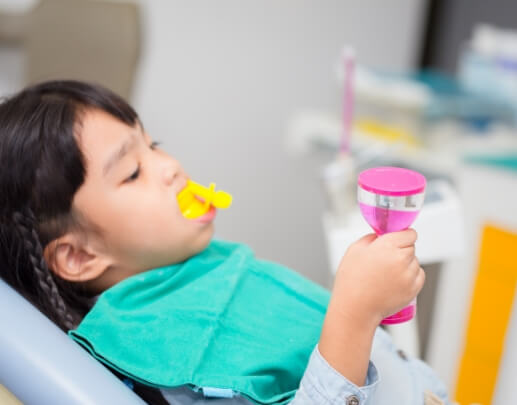 Child receiving fluoride treatment