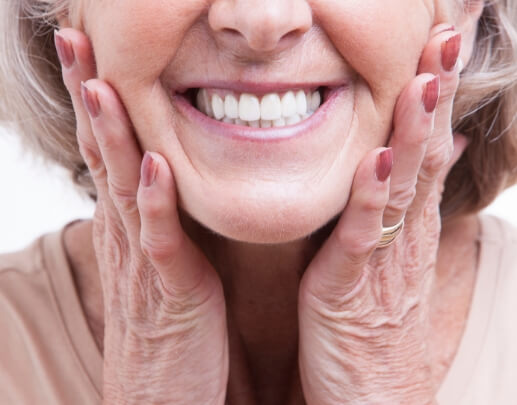 Smiling woman enjoying the benefits of dentures