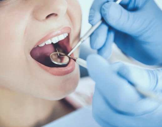 Dentist performing oral cancer screening