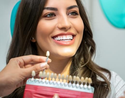 Woman's smile compared with tooth colored filling shade choices
